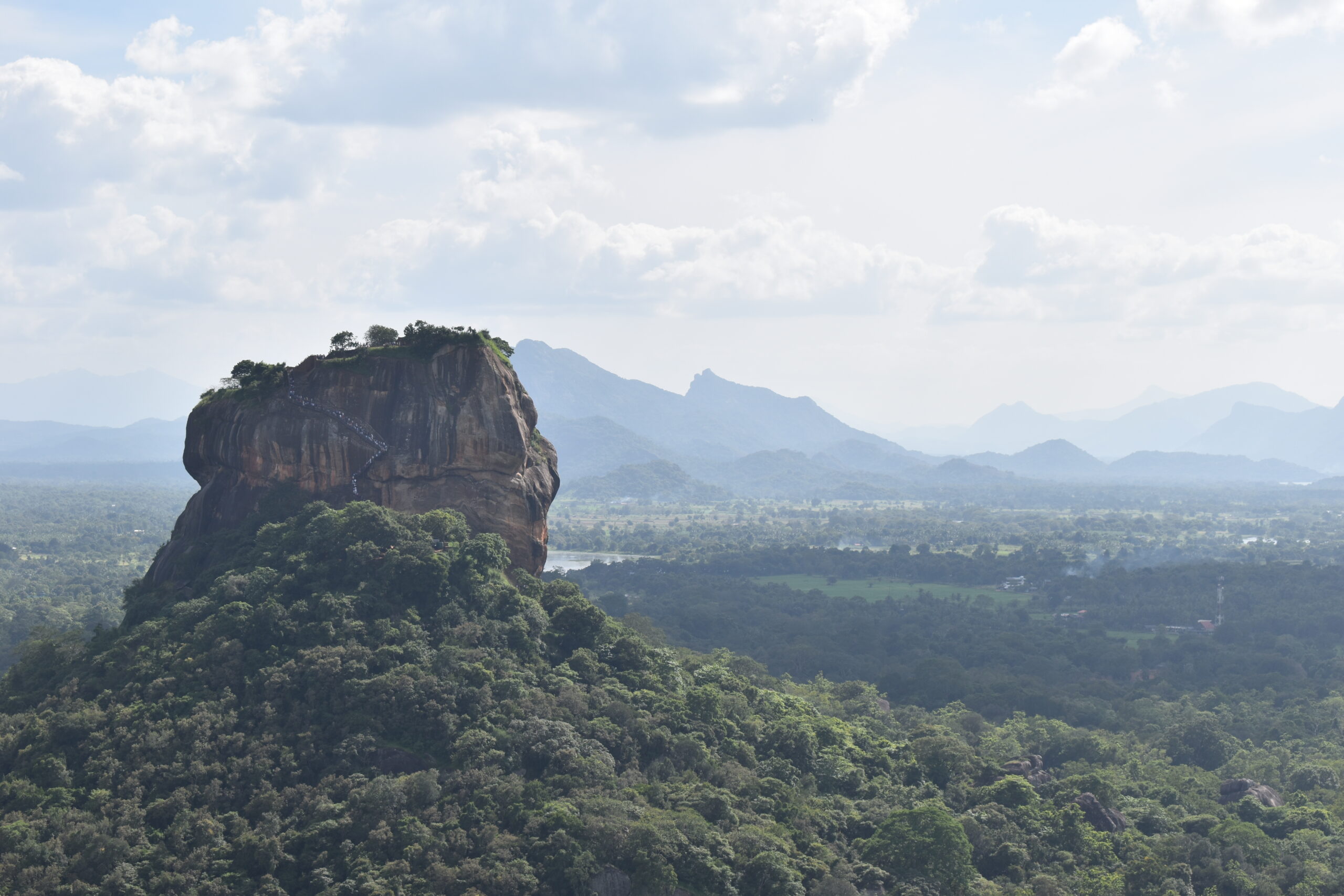 Sigiriya rock fortress seen across the jungle from Pidurangala Rock